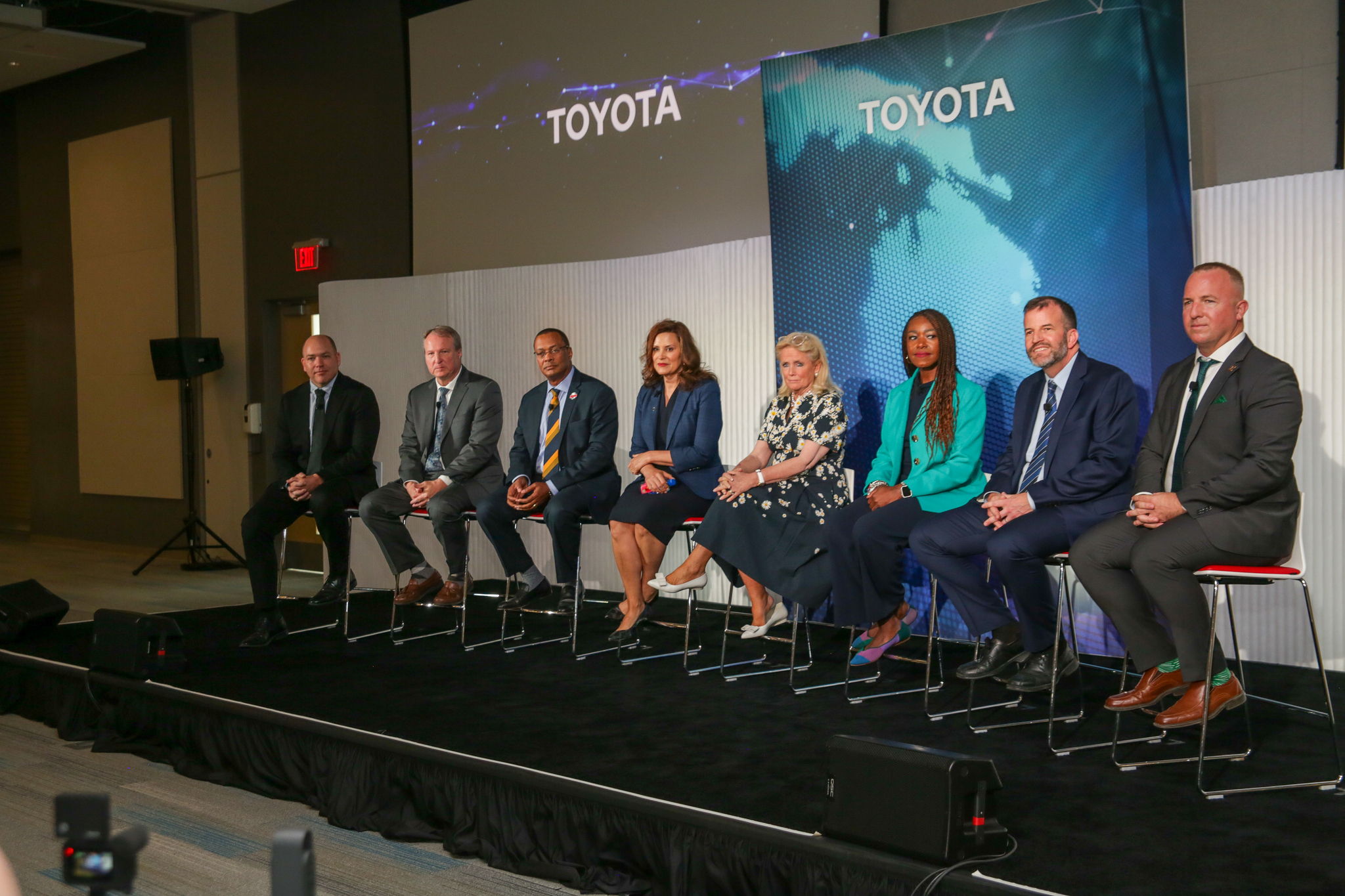 Panelists sit on stage