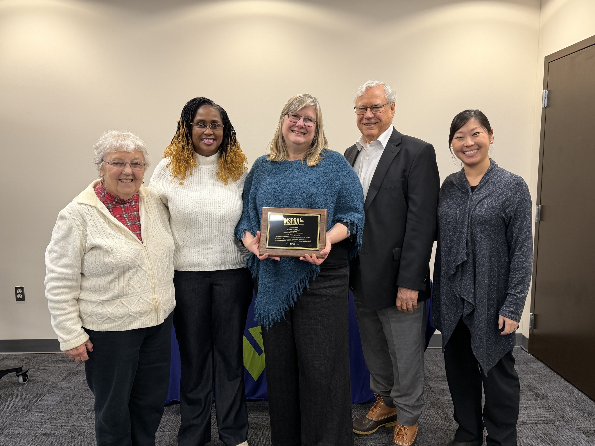 Superintendent Norman stands with her award (middle), with board trustees Diane Hockett, Dorcas Musili, Steve Olsen, and WISD Director of Communications Ashley Kryscynski